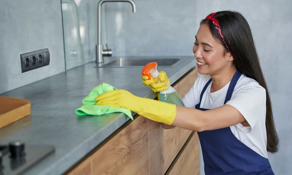happy-young-woman-cleaning-lady-smiling-while-cleaning-the-kitchen.jpg