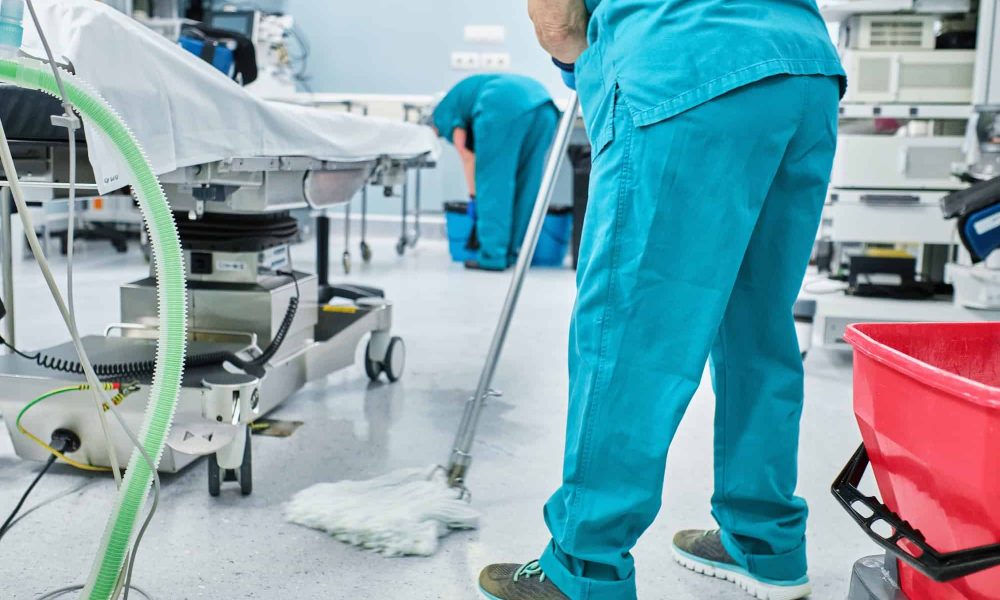 woman-cleaning-staff-mopping-the-floor-of-a-hospital-operating-room.jpg